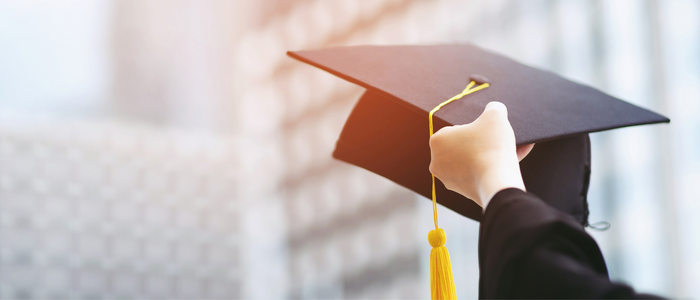 Picture of someone holding a black graduation cap