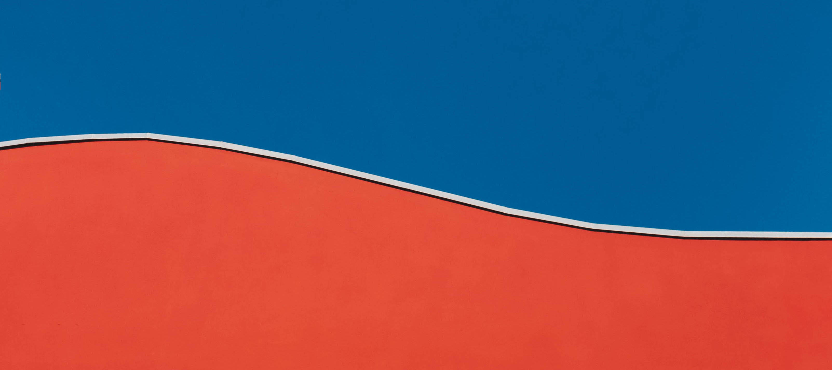 Photo of a wall with the top half blue and the bottom half red