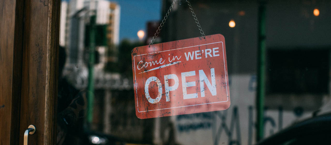 Picture of a red Open sign in a storefront